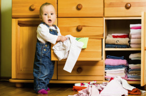 Domestic chores - baby throws out clothes